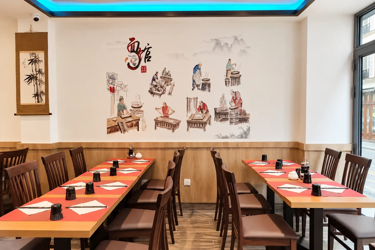 Dining room: wall mural, wooden tables and red placemats